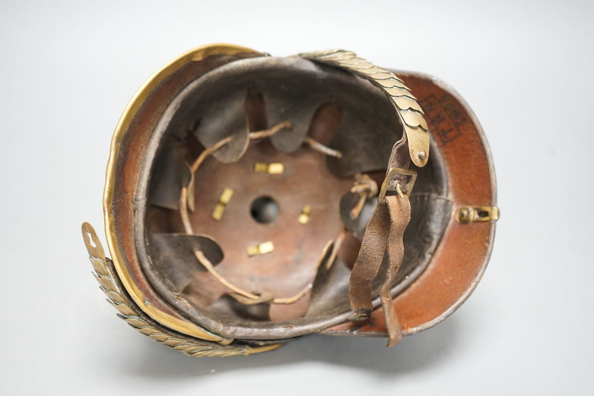 A WW1 Prussian pickelhaube, the leather skull with brass spiked top and eagle plate